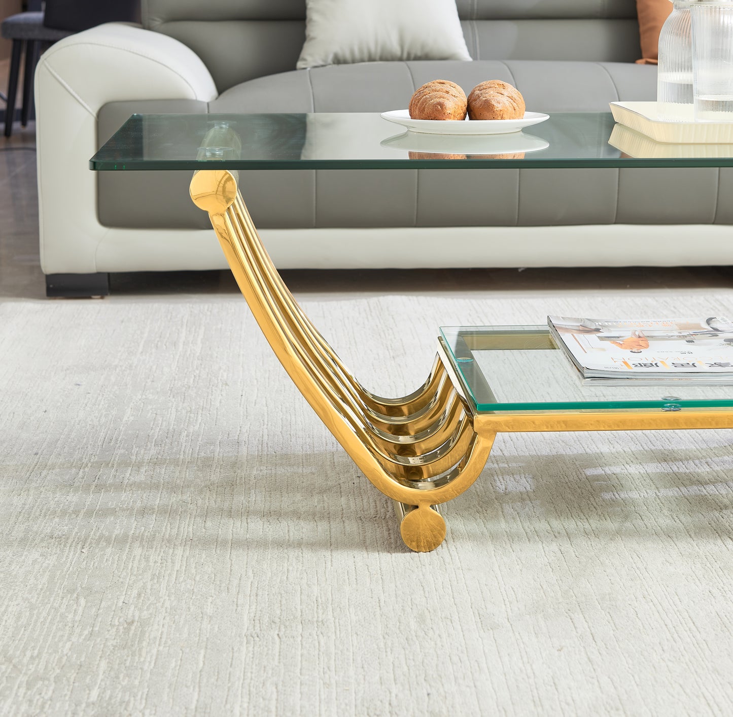 Modern gold leaf coffee table with glass top and contemporary design