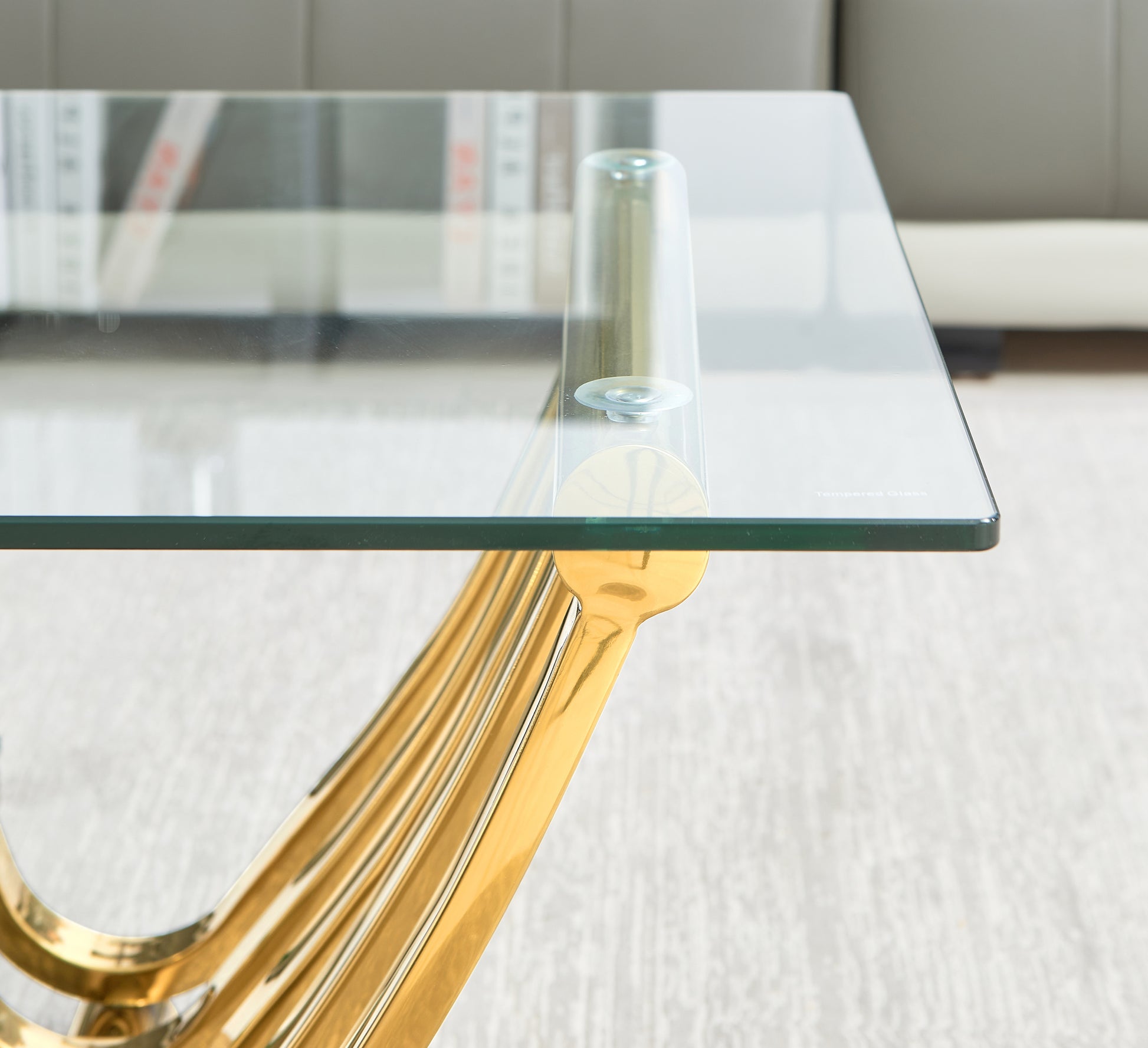 Modern glass coffee table with polished gold pedestal base sleek and elegant design