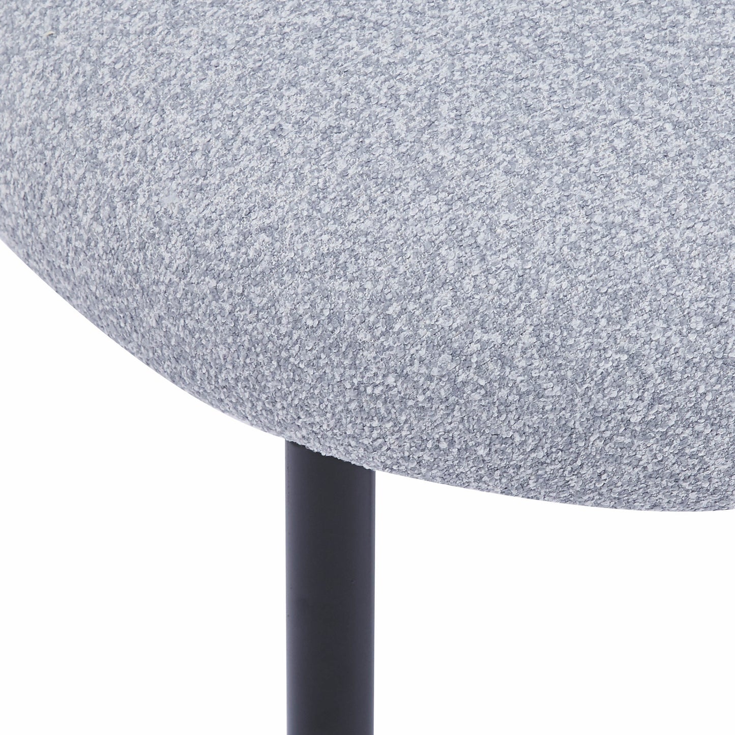 Closeup of light grey textured boucle fabric on a modern stool seat