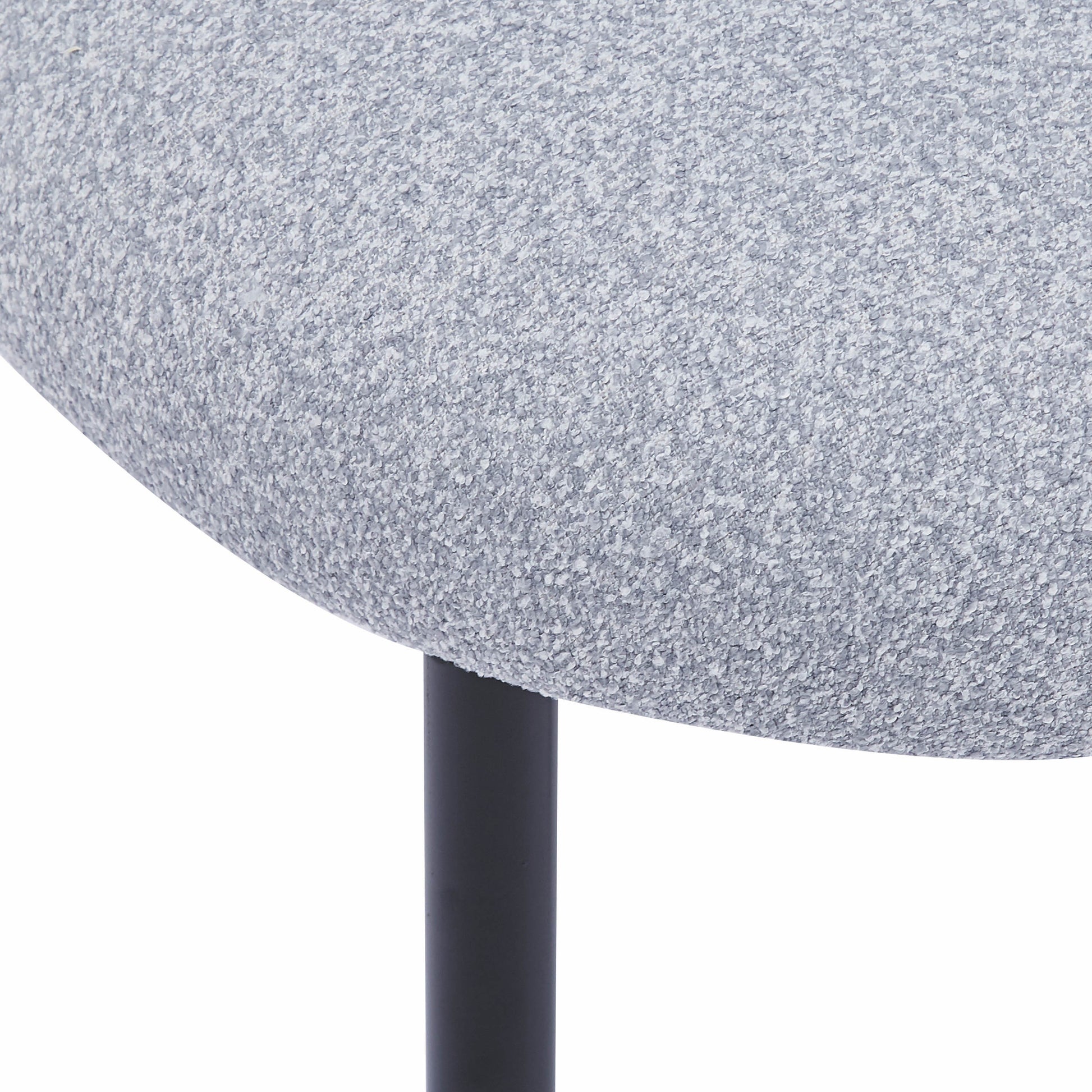 Closeup of light grey textured boucle fabric on a modern stool seat