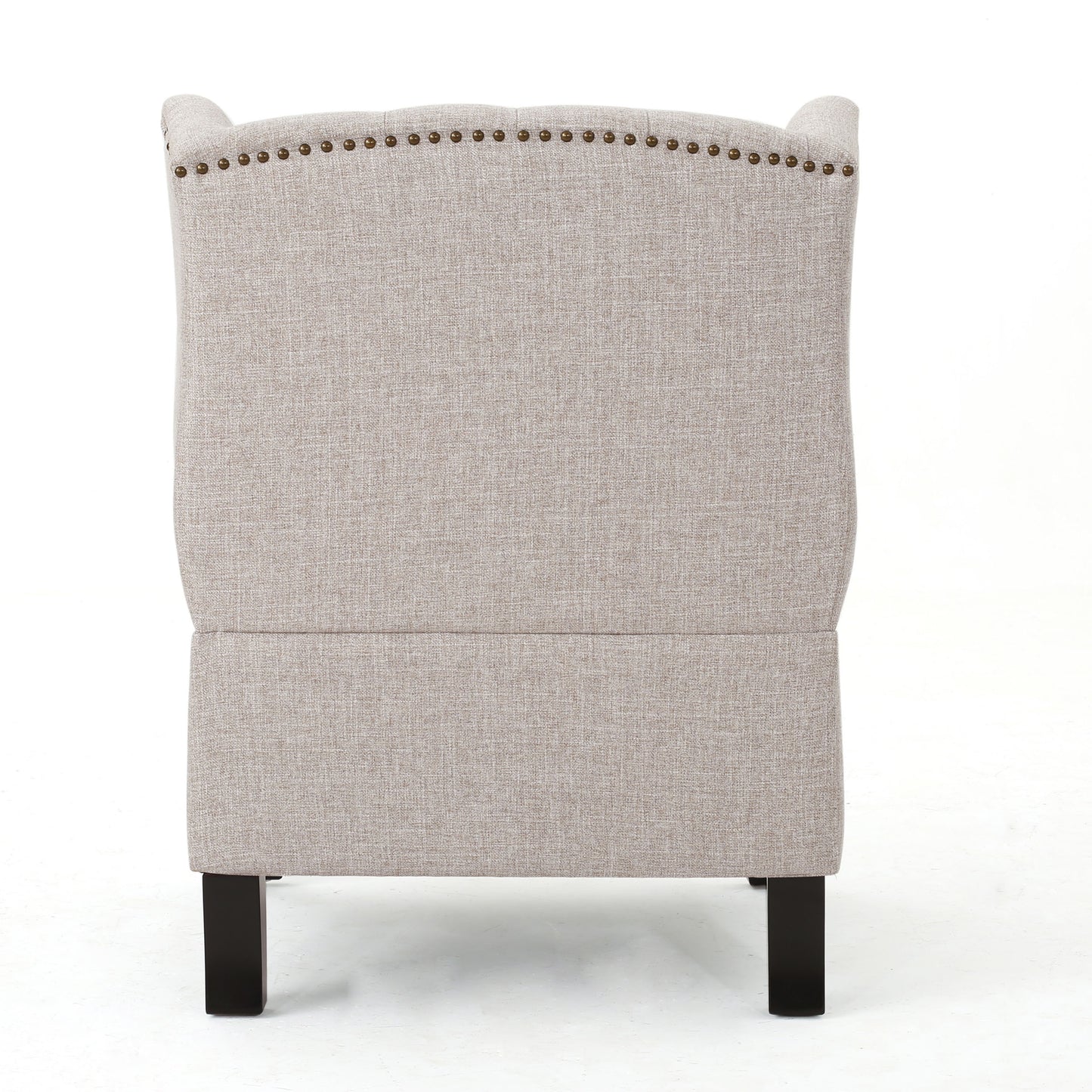 Back view of a beige upholstered wingback chair with brass nailhead trim