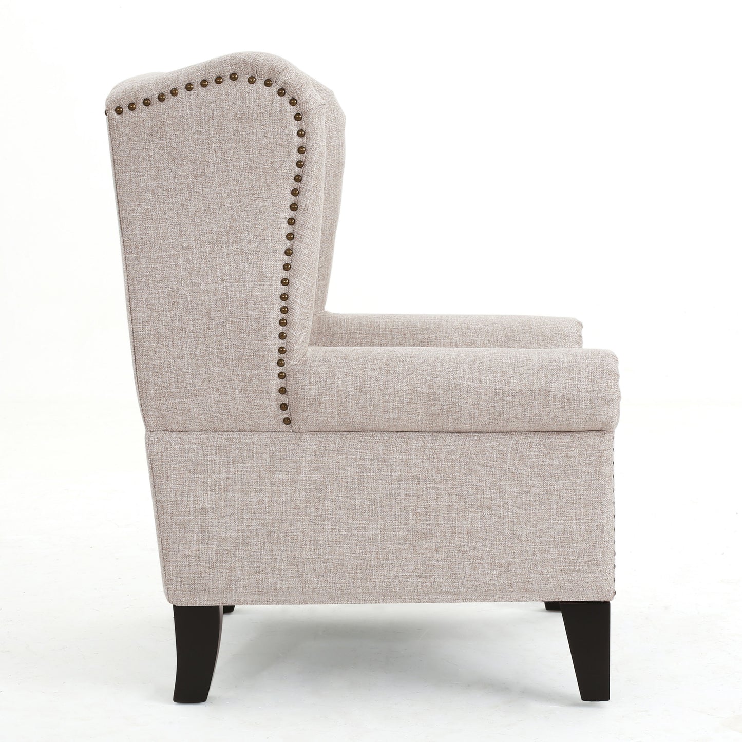 Beige linen wingback armchair with brass nailhead trim and dark wood legs