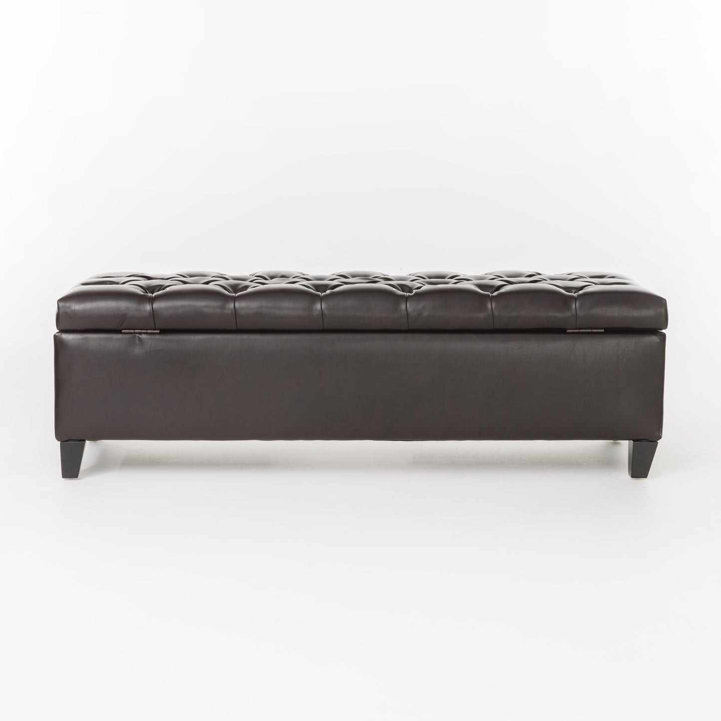 Dark brown tufted faux leather storage ottoman with hinged top and black legs