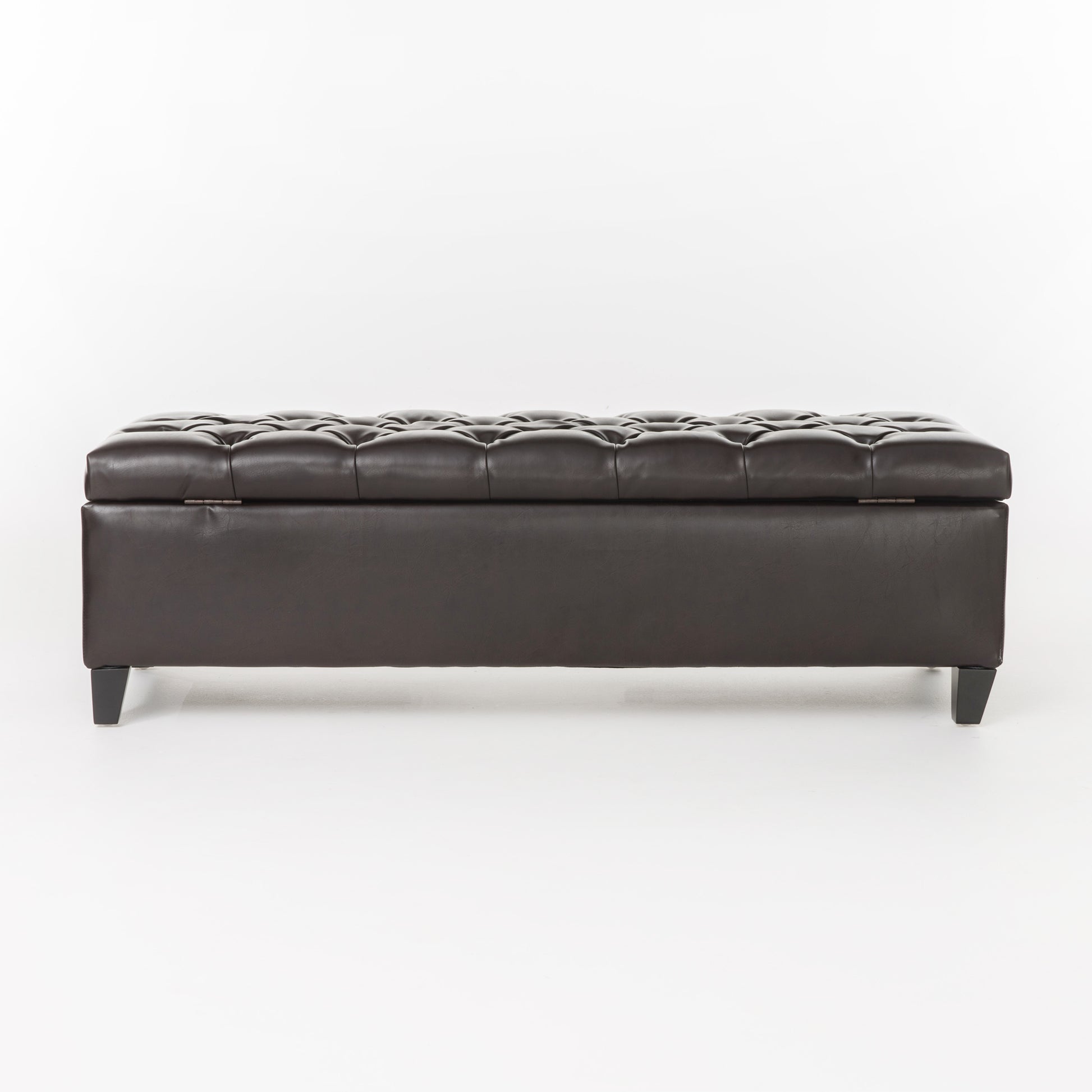 Dark brown tufted faux leather storage ottoman with hinged top and black legs