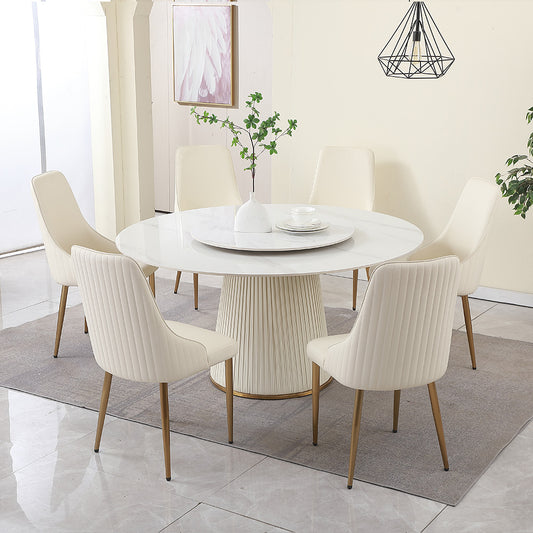 Cream upholstered dining chairs with gold legs around a white marbletop dining table