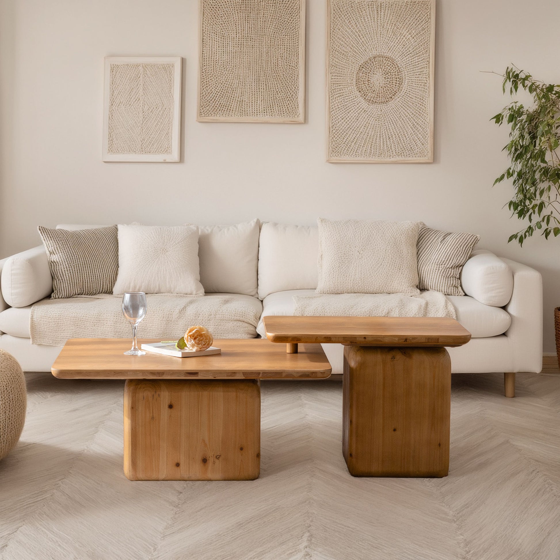 Modern living room with a white sofa natural wood coffee tables and textured wall art