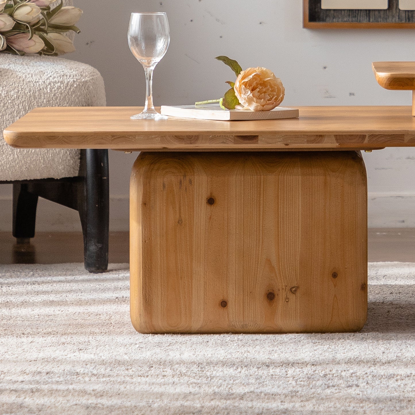 Solid wood coffee table with rounded edges and a distinctive barrelshaped base