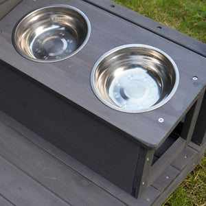 Elevated dog feeder with two stainless steel bowls on a wooden stand