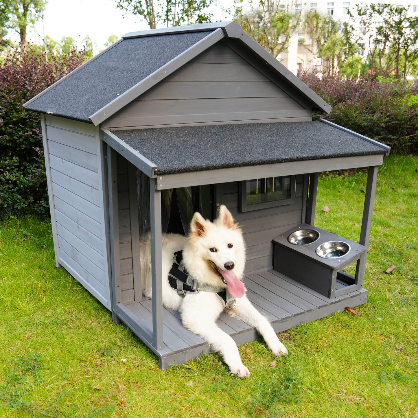 Gray wooden dog house with porch and raised food bowls perfect for outdoor pets
