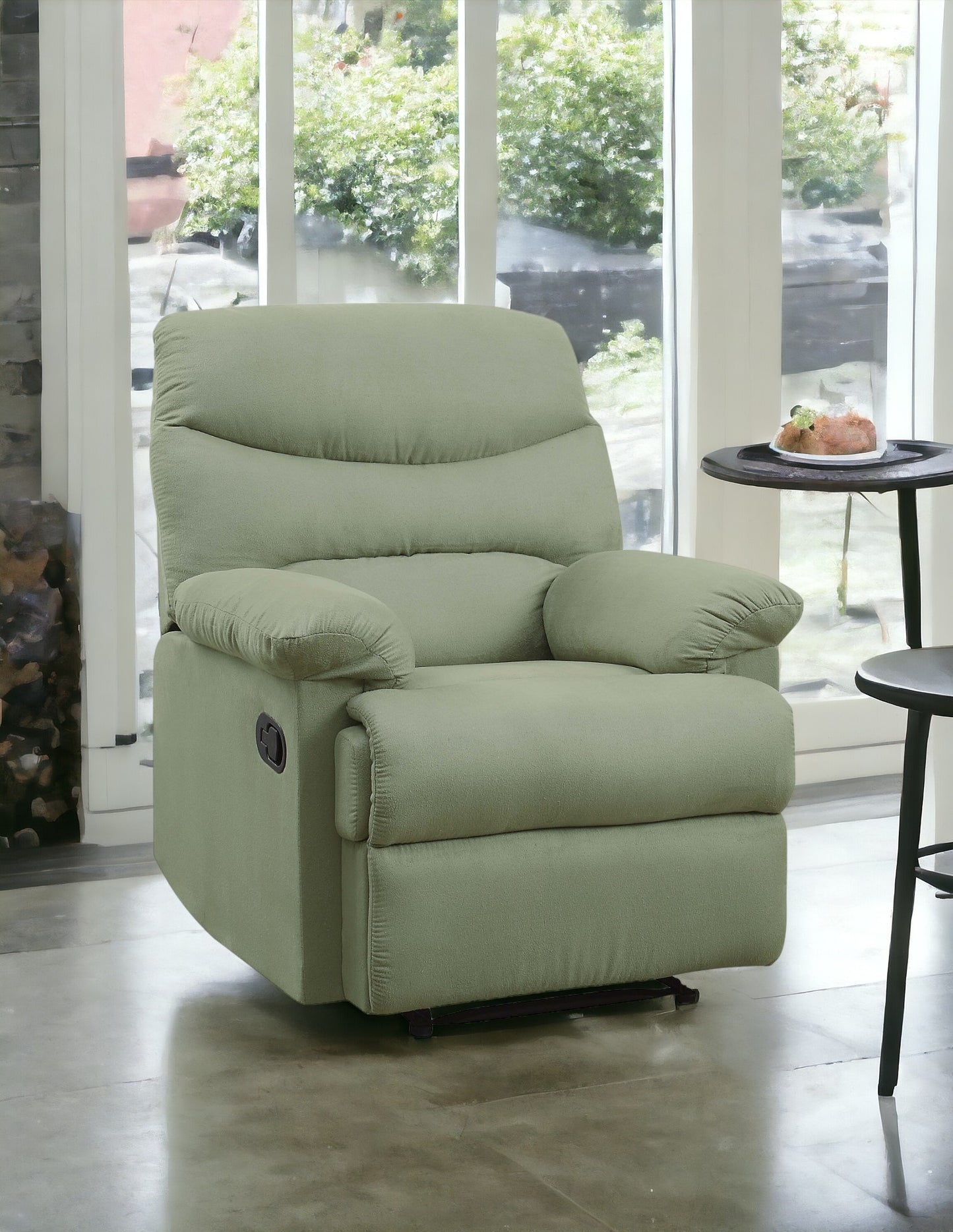 Soft sage green fabric recliner with plush cushioning and convenient side lever