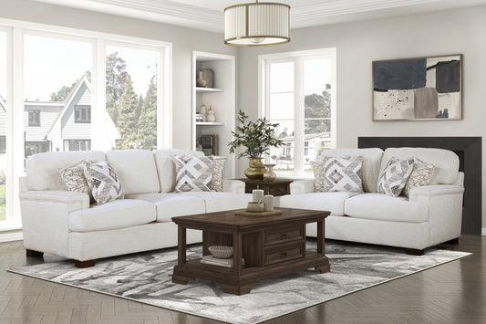 Plush cream fabric sofa with geometric accent pillows and mahogany coffee table