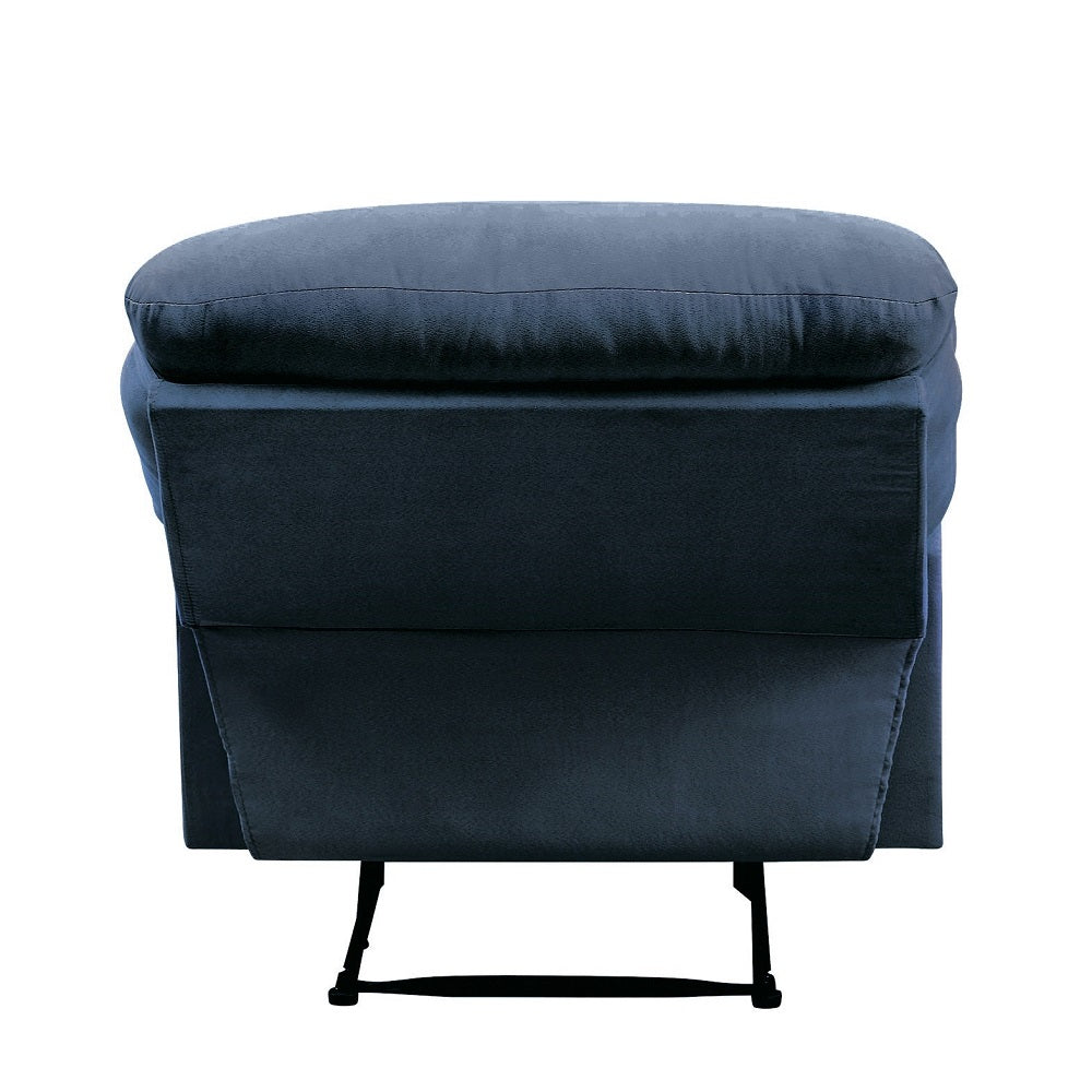 Navy blue velvet armchair with plush cushioning and slim black legs