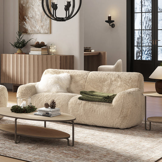 Plush beige sofa with a textured throw perfect for a cozy living room escape