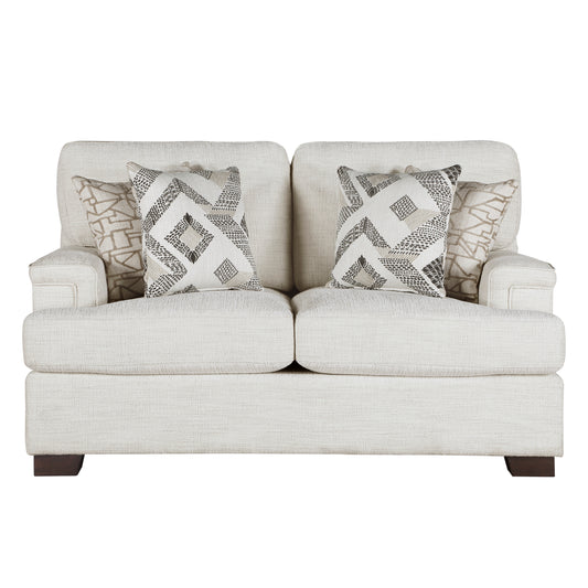 Cream upholstered loveseat with geometric pattern throw pillows and dark wood legs