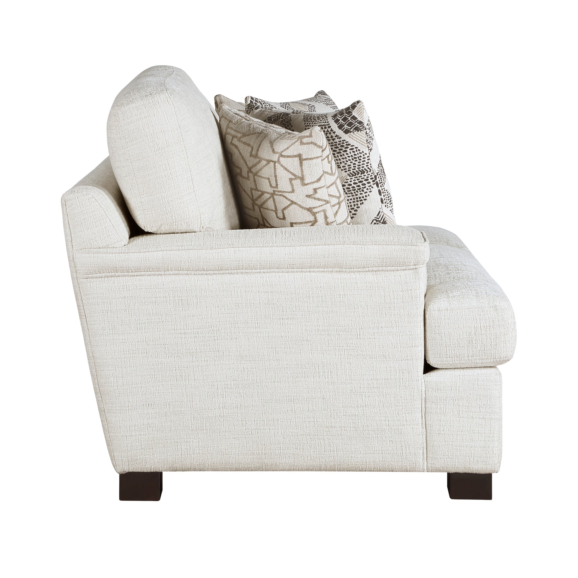 Cream textured armchair with patterned throw pillows for a cozy living room