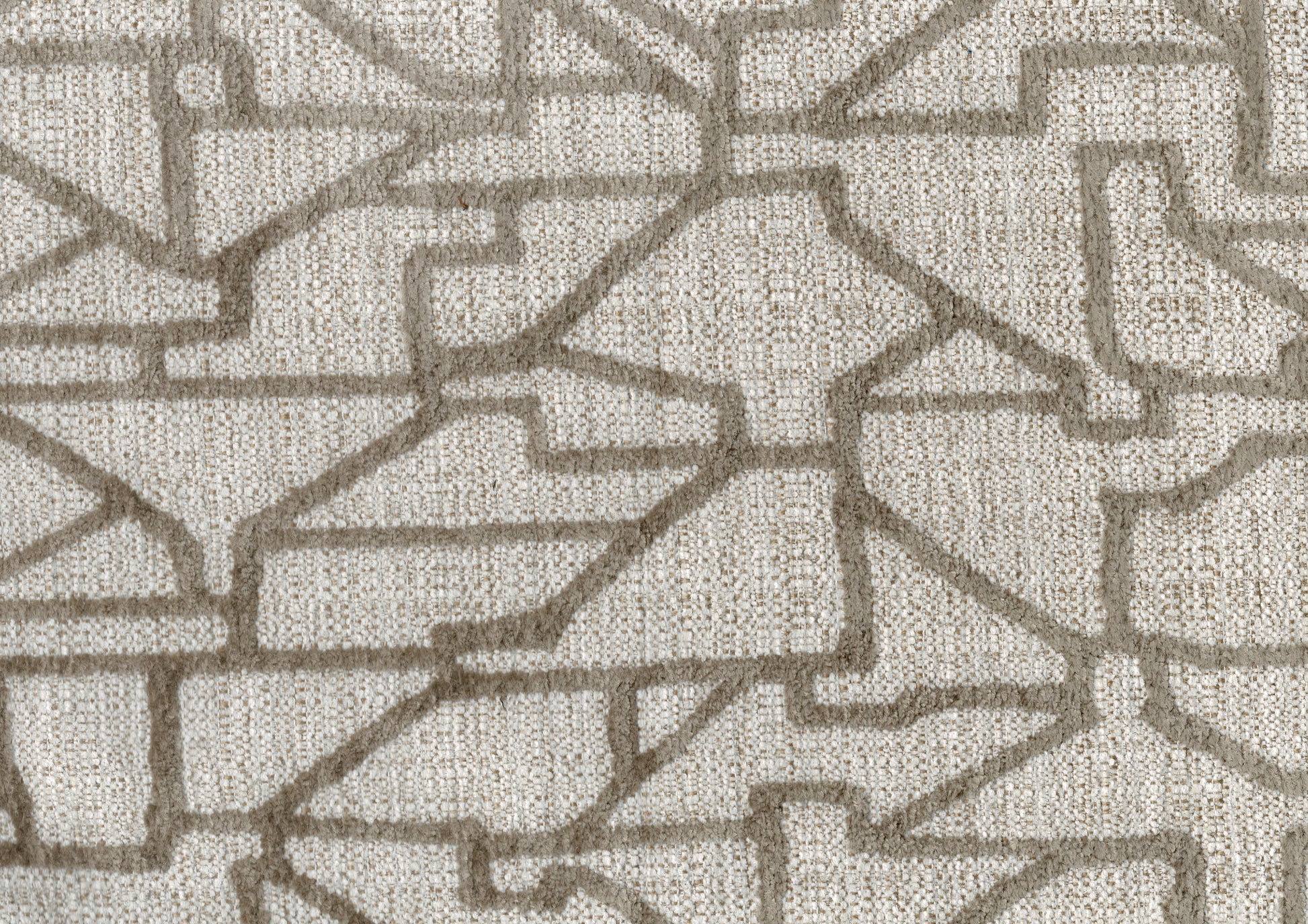 Closeup of textured beige fabric with an abstract geometric pattern in taupe chenille
