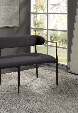Dark gray upholstered bench with gold accents and black legs
