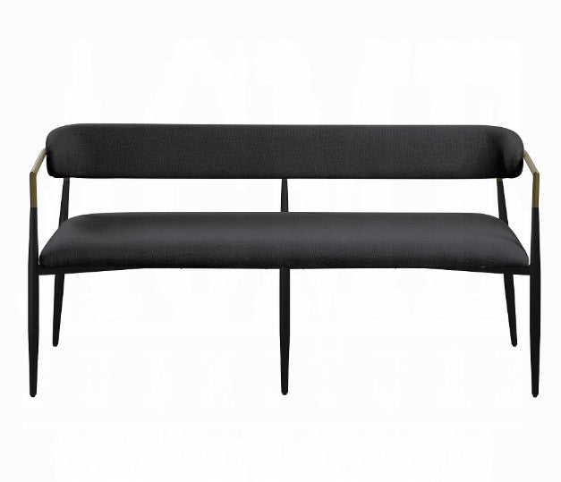 Black fabric bench with slender black legs and gold accents