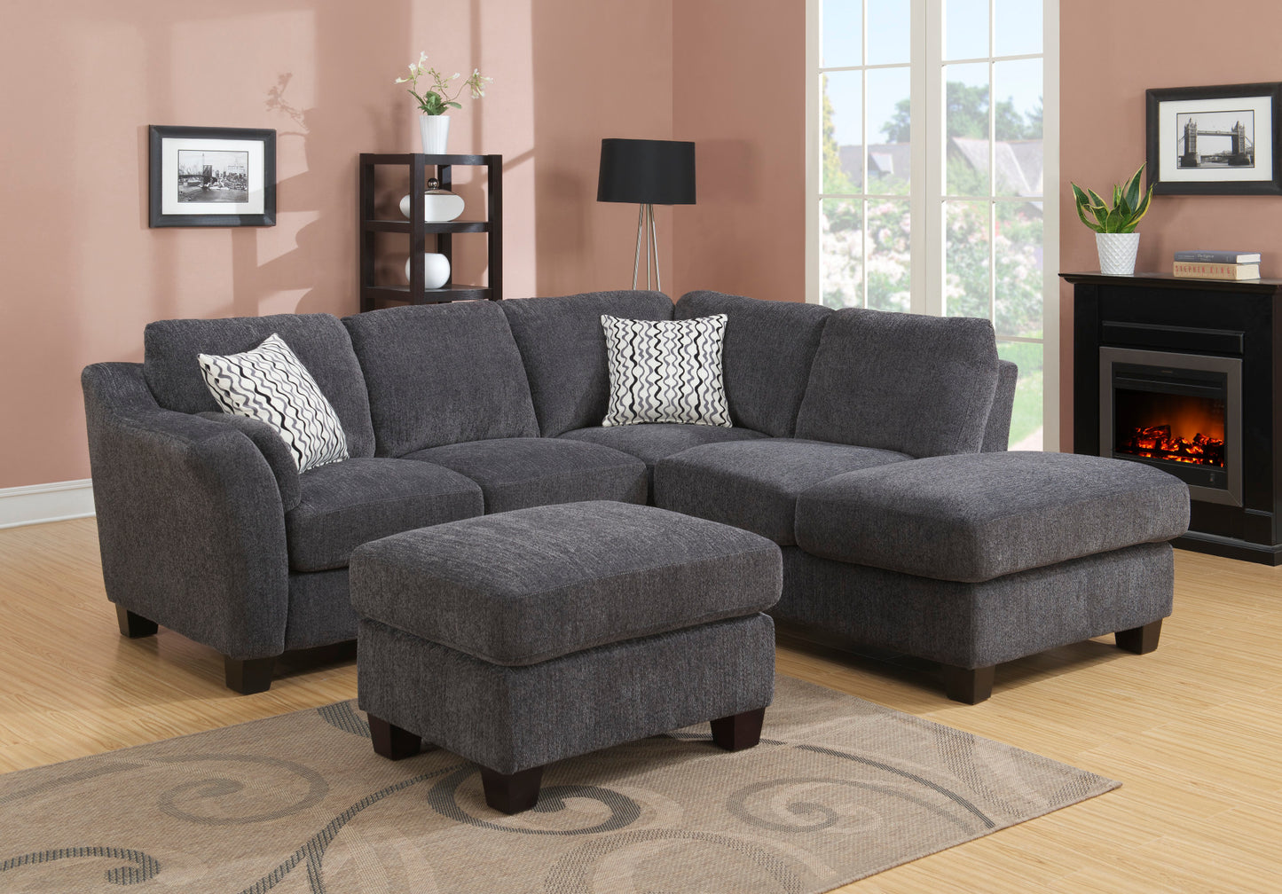 Dark grey fabric sectional sofa with geometric pattern throw pillows and matching ottoman