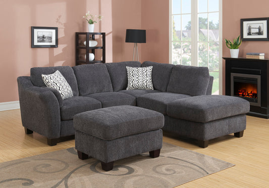 Dark grey fabric sectional sofa with geometric pattern throw pillows and matching ottoman