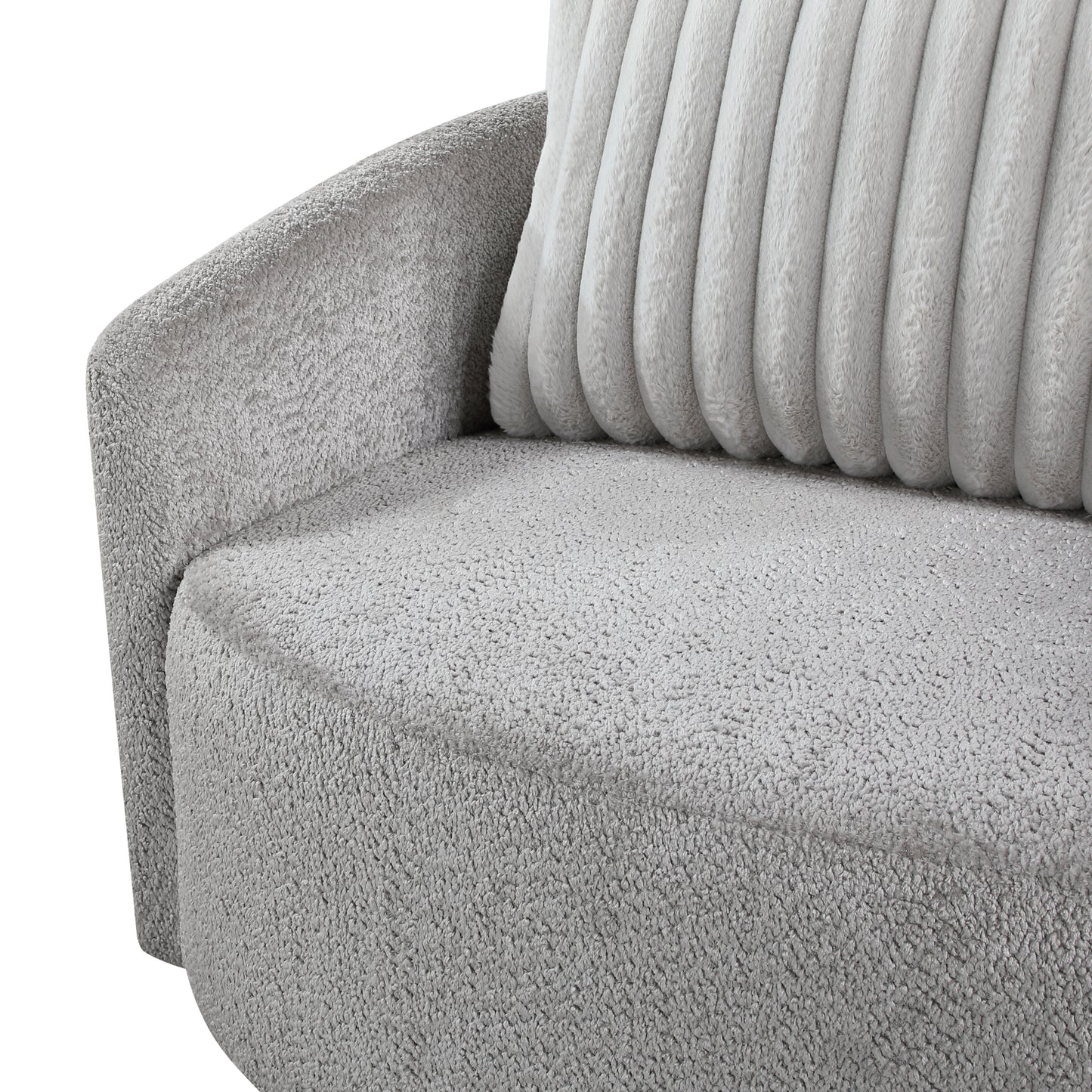 Closeup of a plush grey armchair armrest and seat with a ribbed cushion
