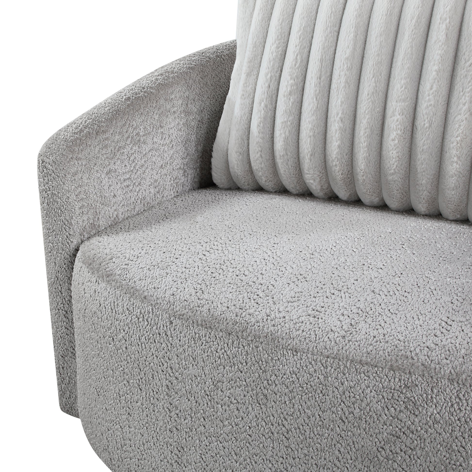 Closeup of a plush grey armchair armrest and seat with a ribbed cushion