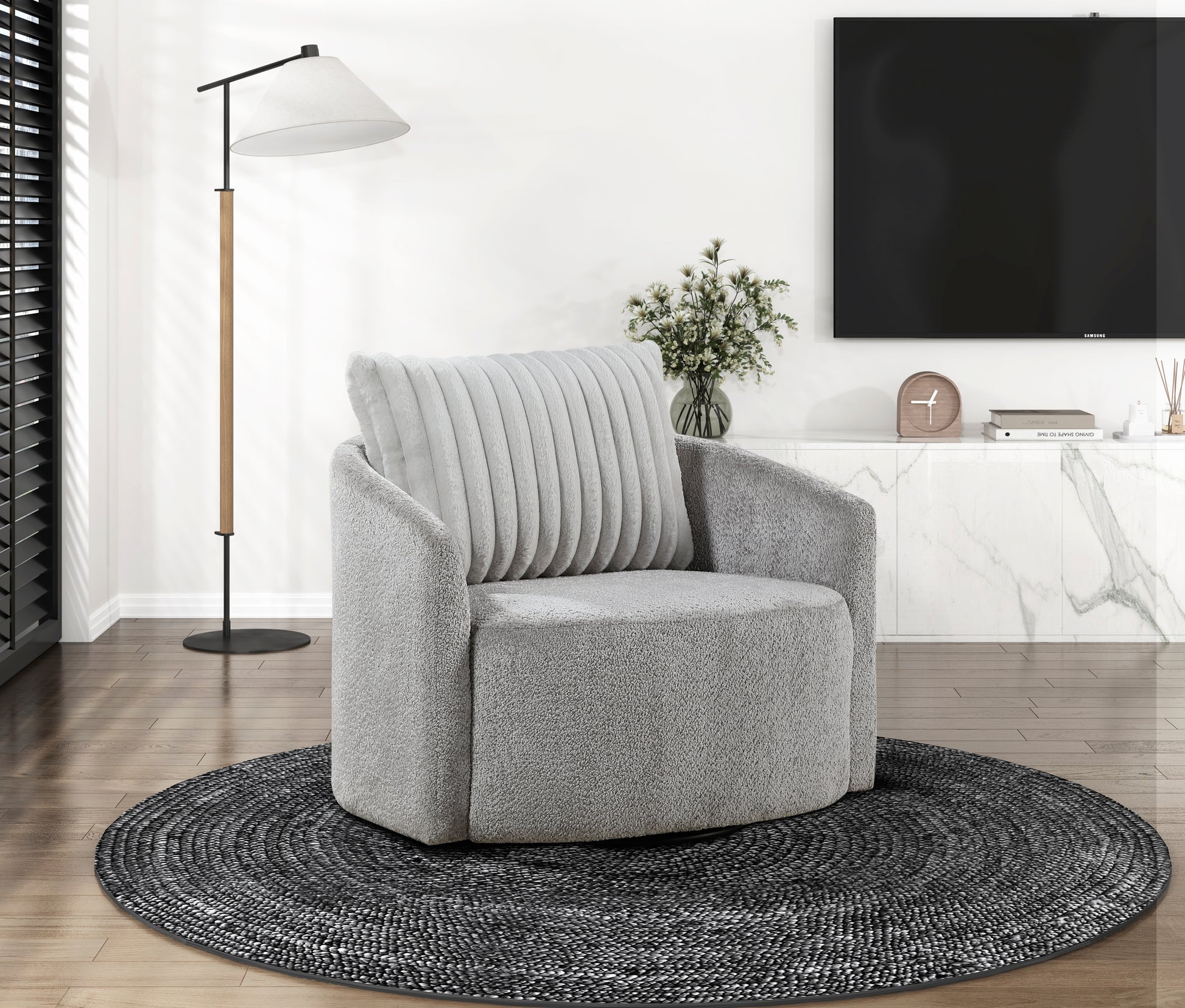 Plush grey swivel armchair with a textured finish and plush ribbed back cushion