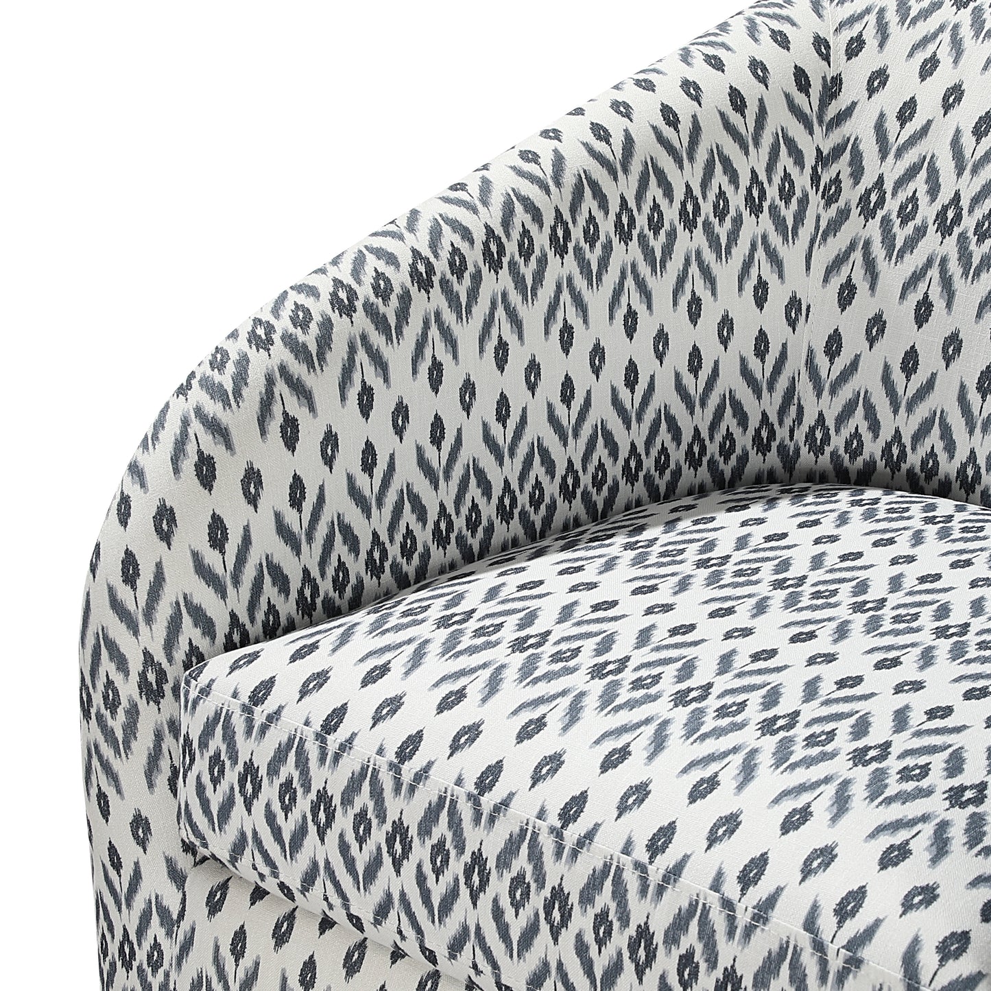 Closeup of a textured fabric armchair with a grey and white abstract ikat pattern