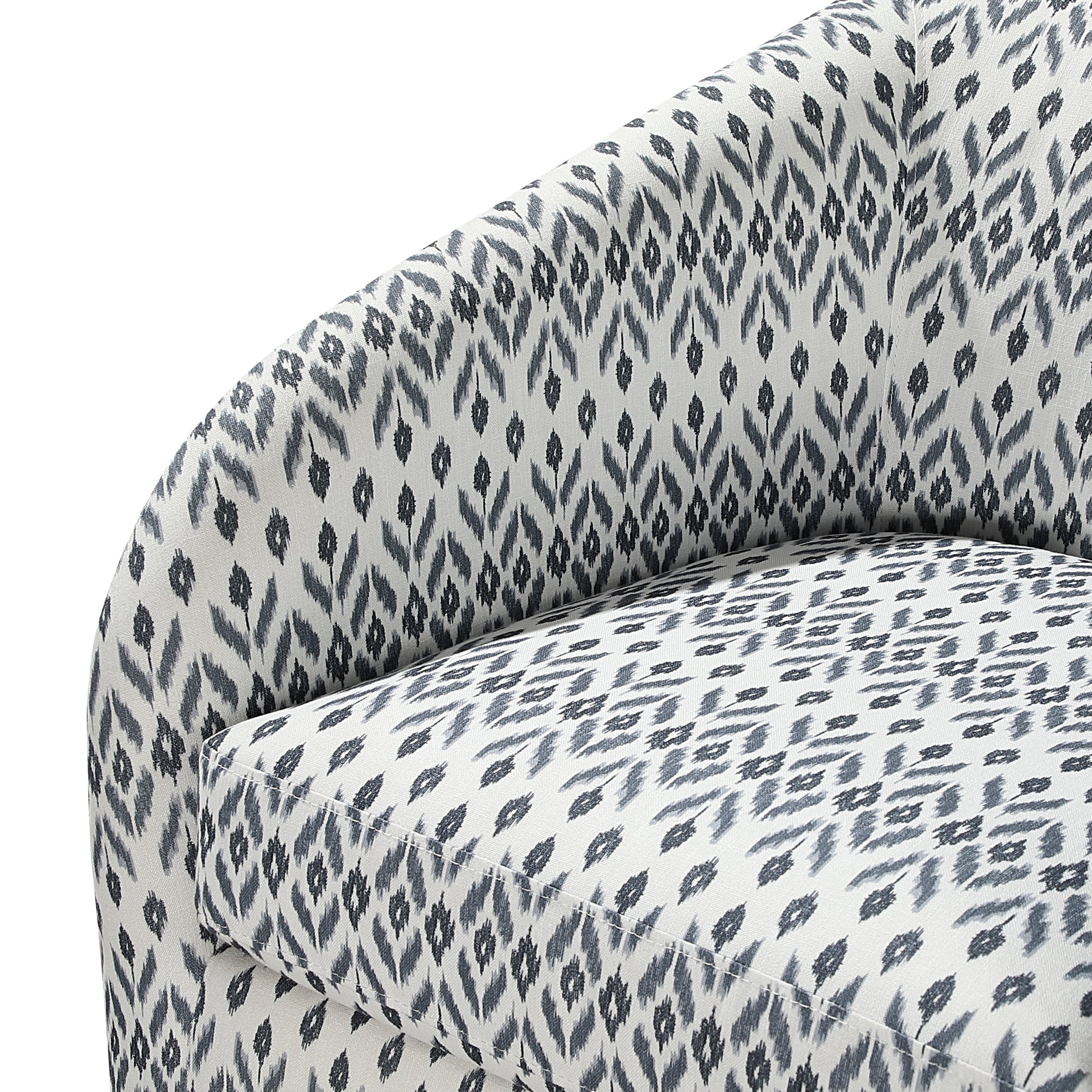 Closeup of a textured fabric armchair with a grey and white abstract ikat pattern