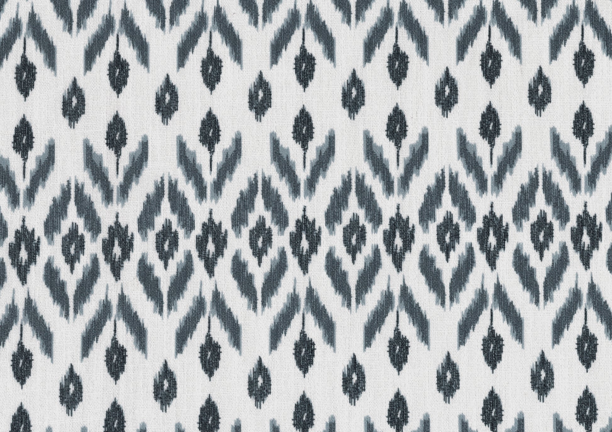 White and grey ikat fabric with a repeating diamond pattern perfect for home decor