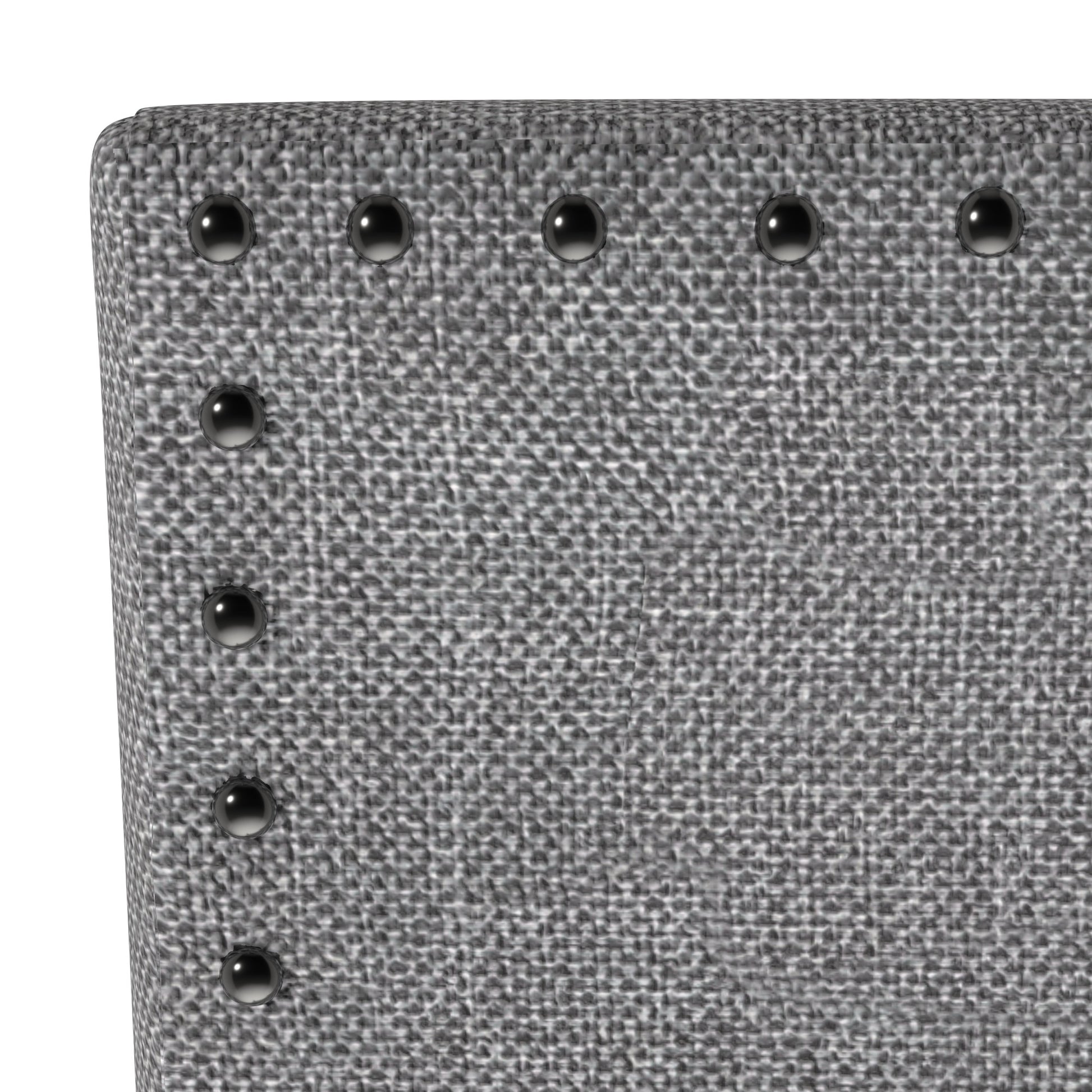 Close up of a grey textured fabric chair with silver nailhead trim detail