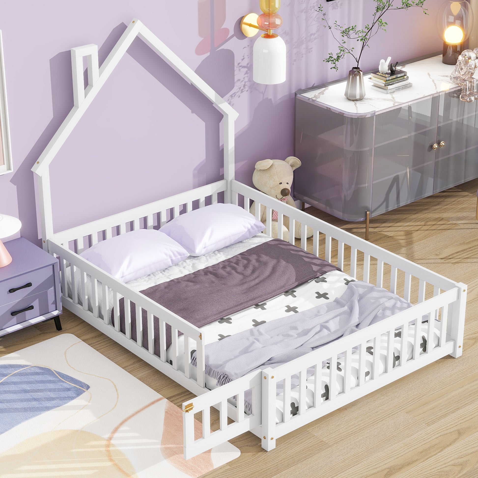White wooden house bed frame with safety rails for toddlers featuring playful bedding