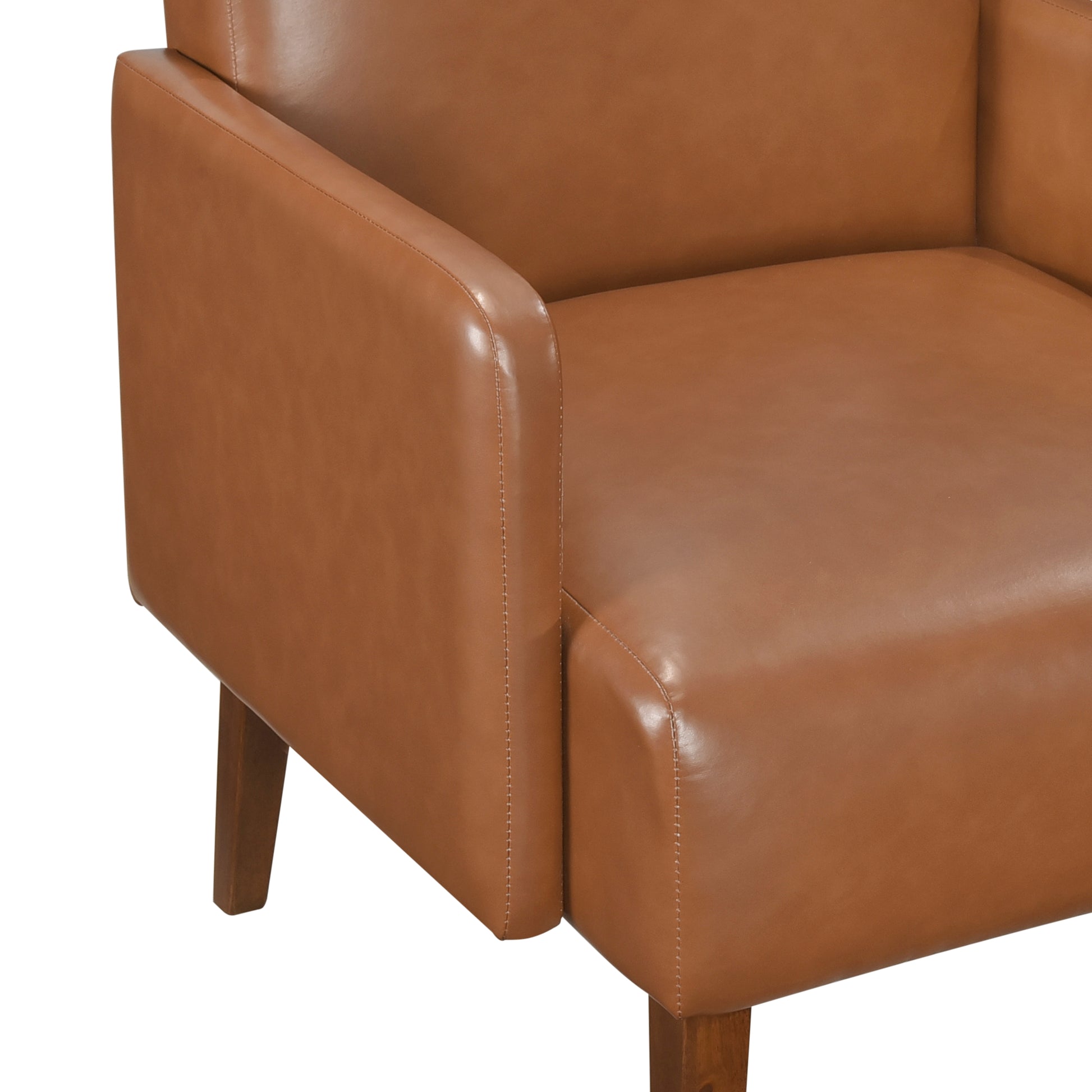 Closeup of a tan leather accent chair armrest with visible stitching and wooden leg detail