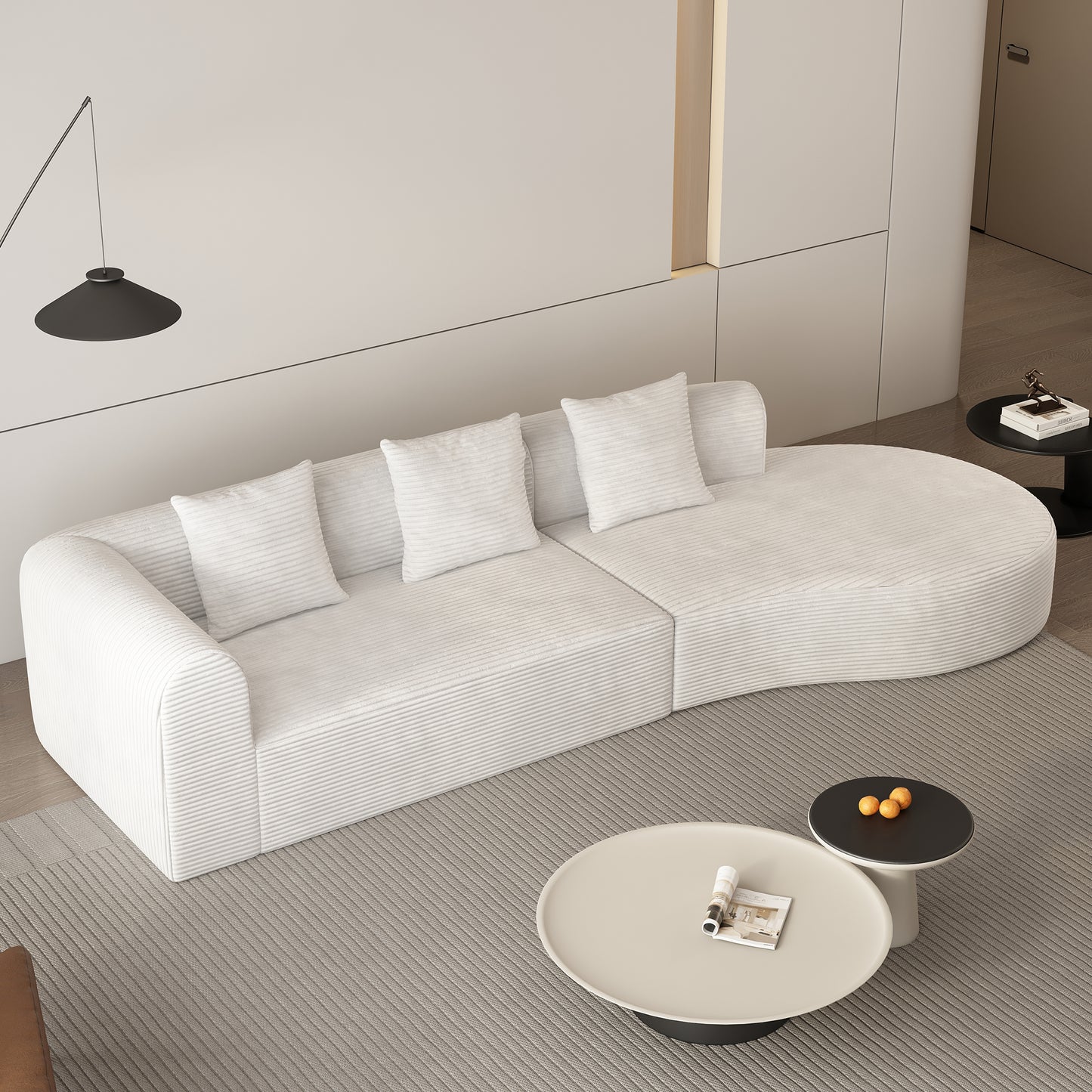 Curved white corduroy sofa with plush pillows in a modern living room