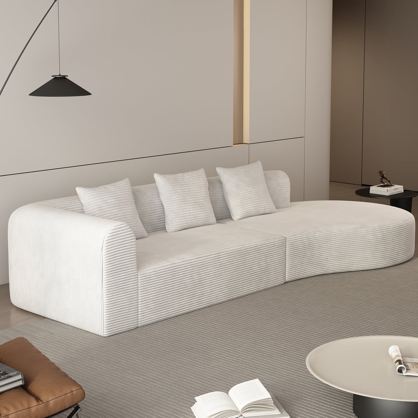 Curved white corduroy sectional sofa with three plush pillows perfect for modern living rooms