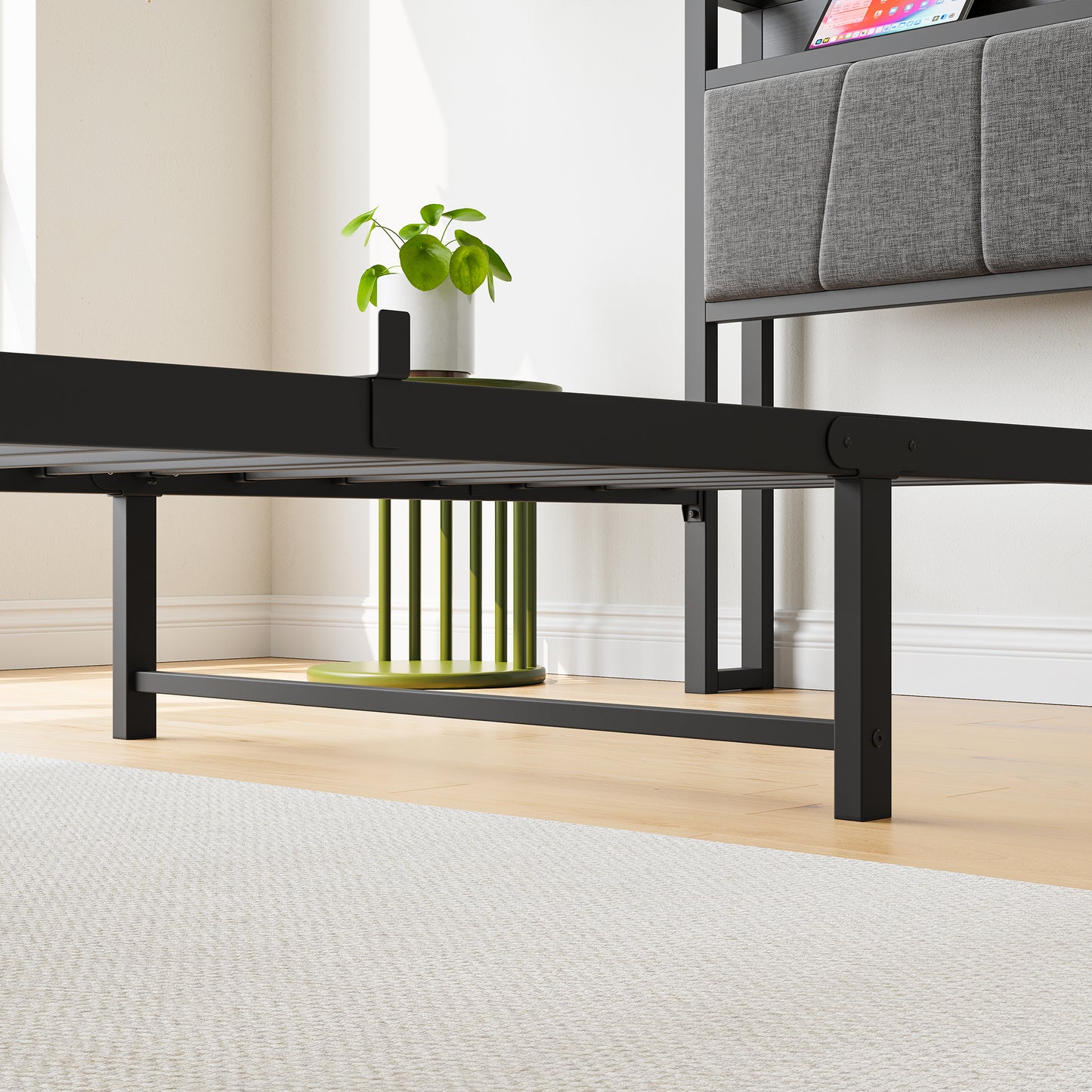 Black metal bed frame with upholstered gray headboard and integrated charging station