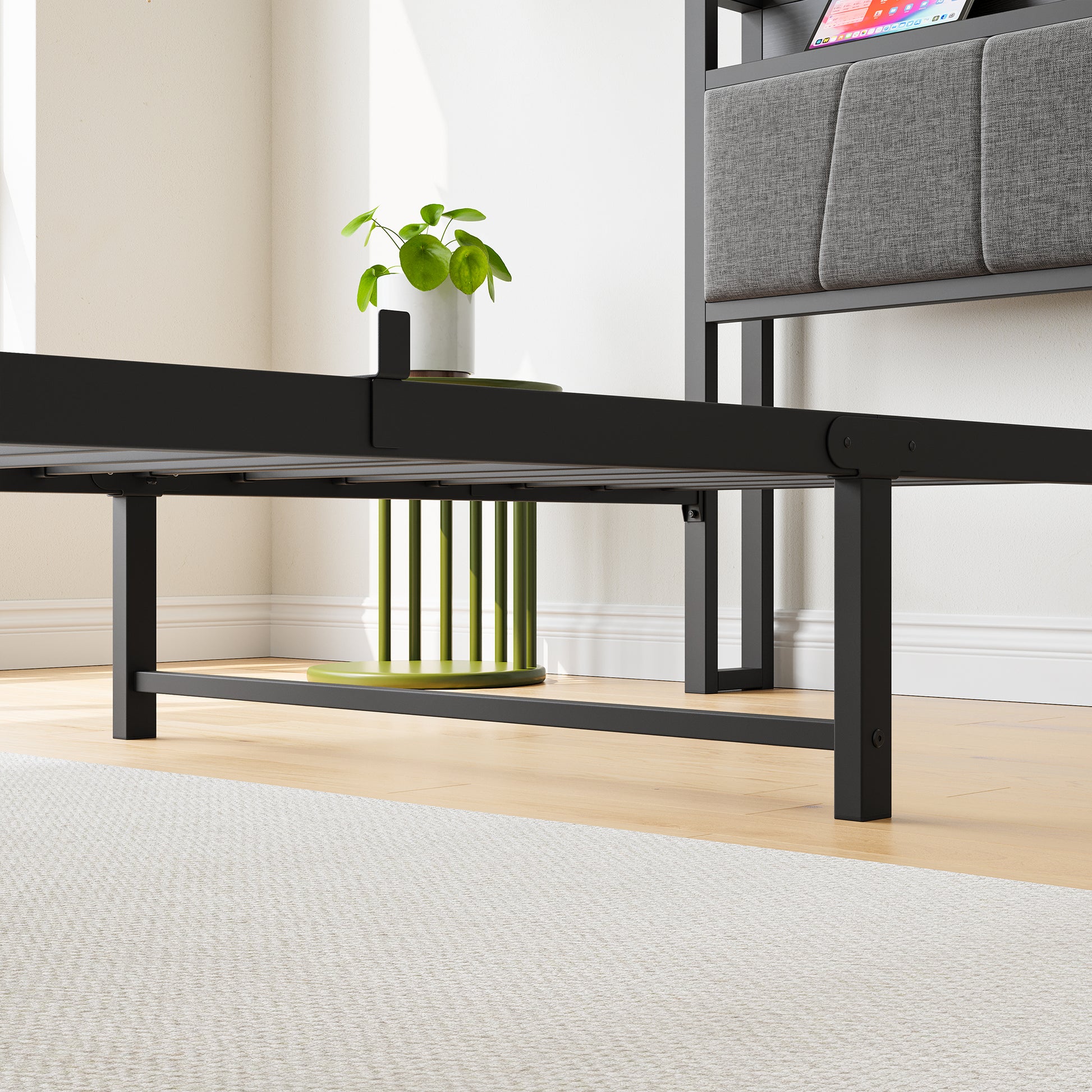 Black metal bed frame with upholstered gray headboard and integrated charging station