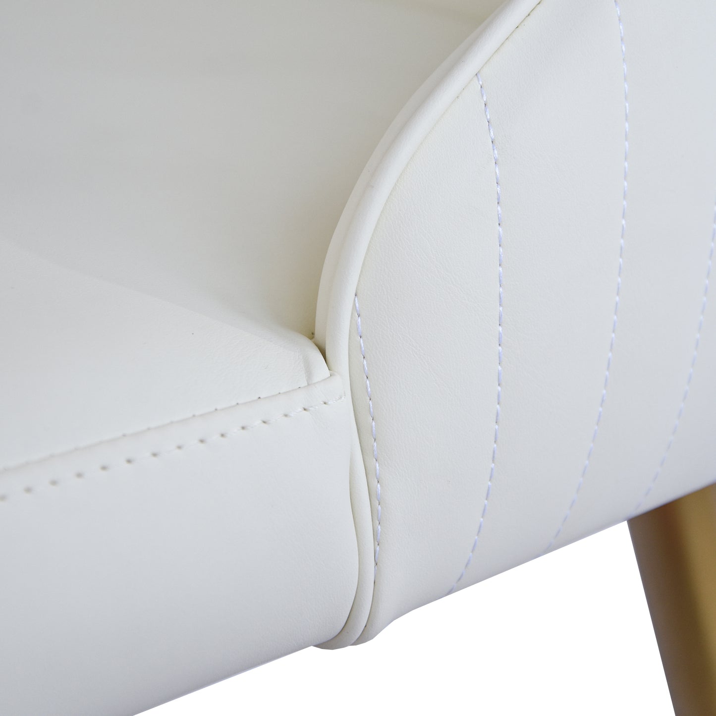 Closeup of white faux leather armchair with subtle stitching detail