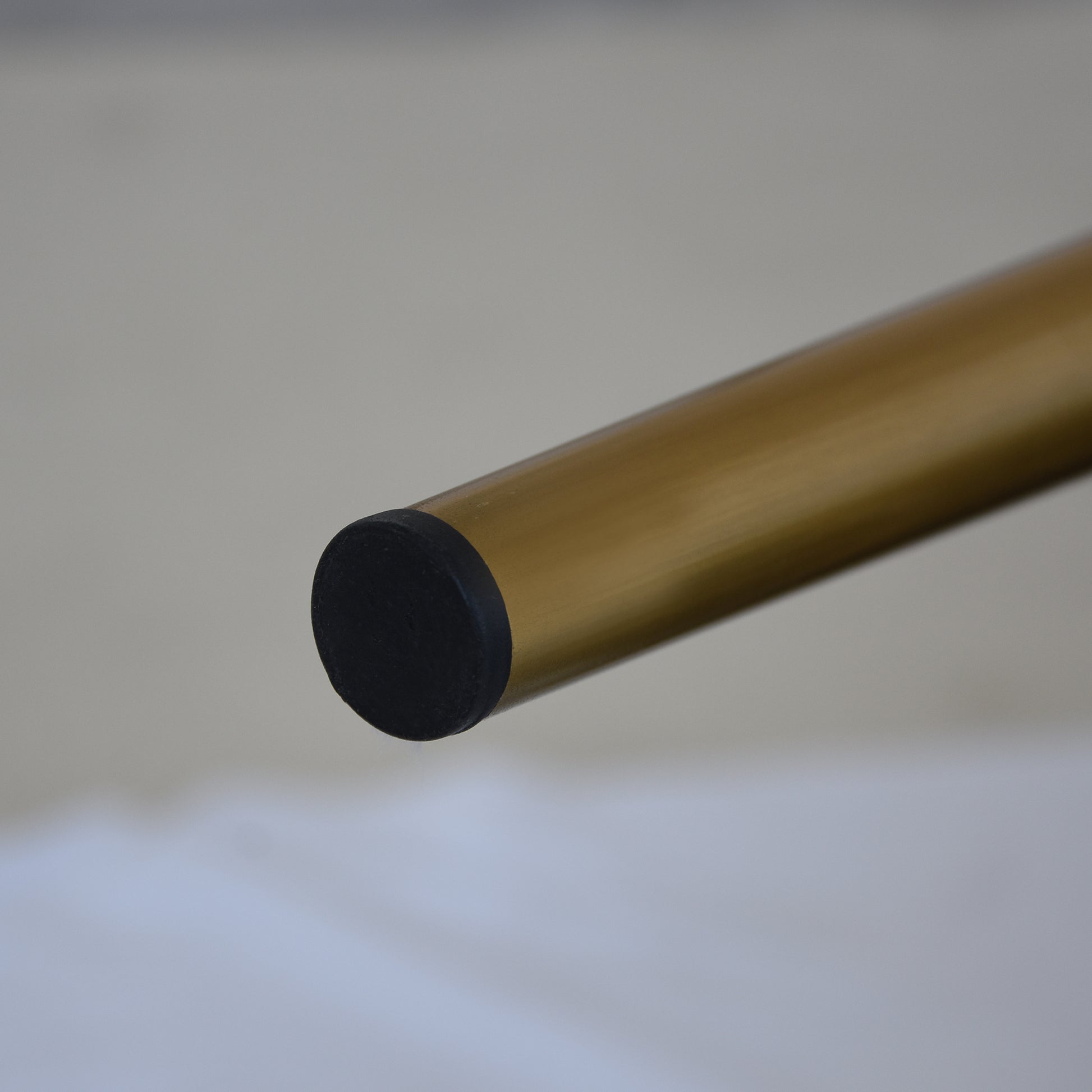 Gold metal furniture leg with black protective cap modern design