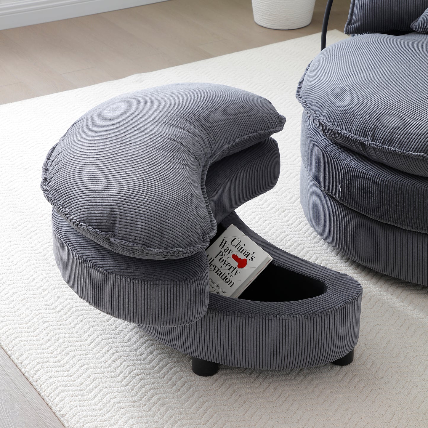 Grey corduroy ottoman with hidden storage and a curved backrest perfect for modern living rooms