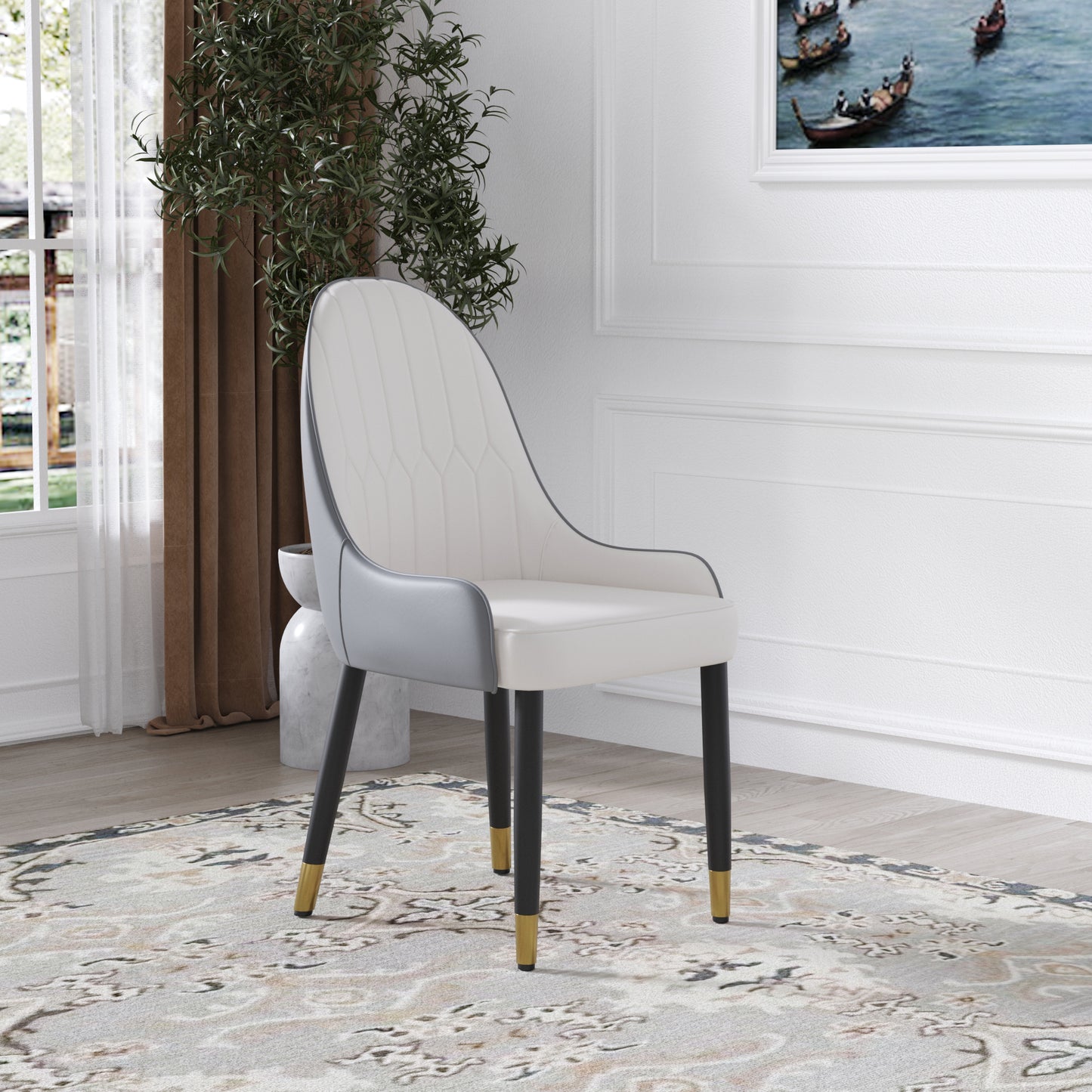Cream upholstered dining chair with gray accents and goldtipped black legs