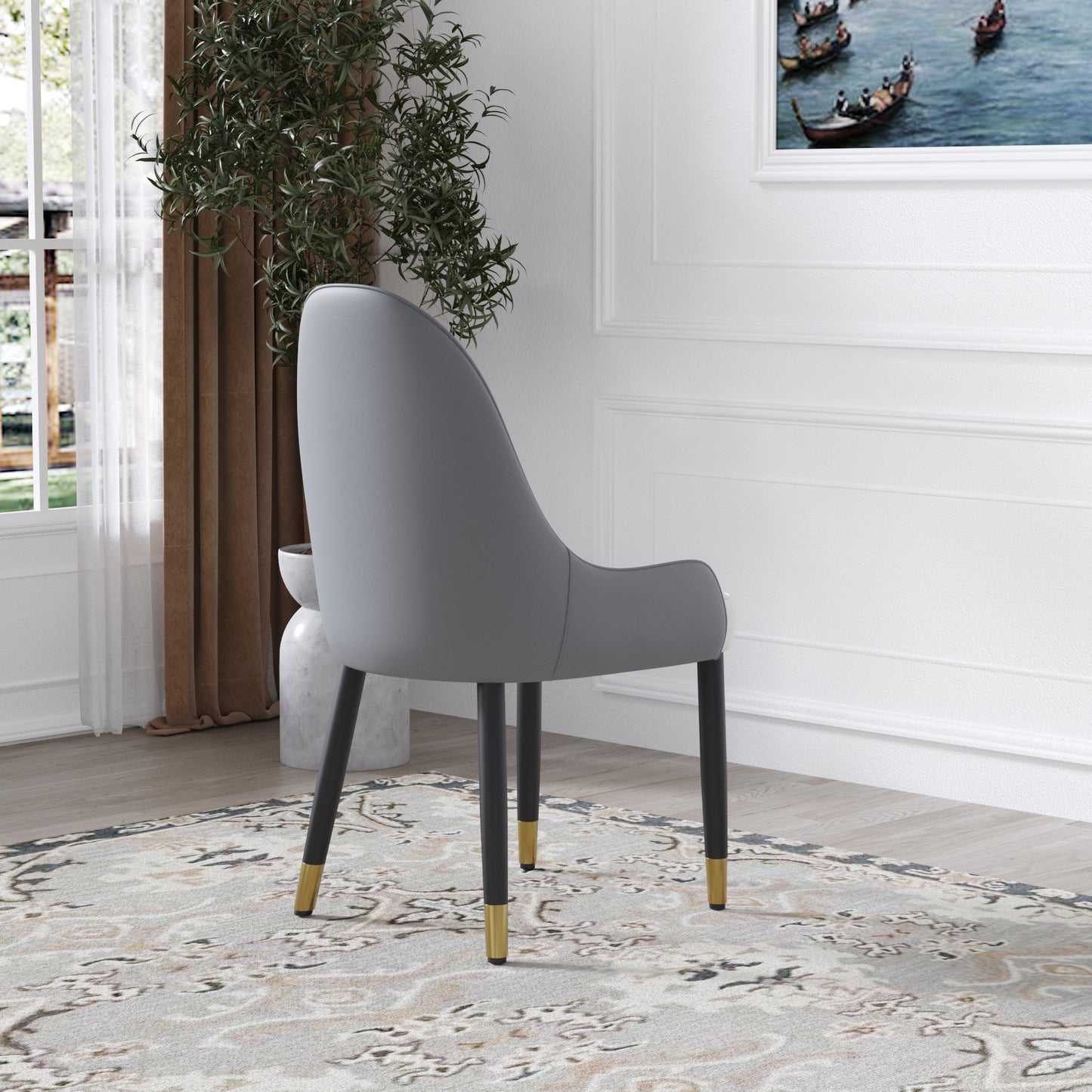 Grey upholstered accent chair with black legs and gold accents perfect for dining rooms