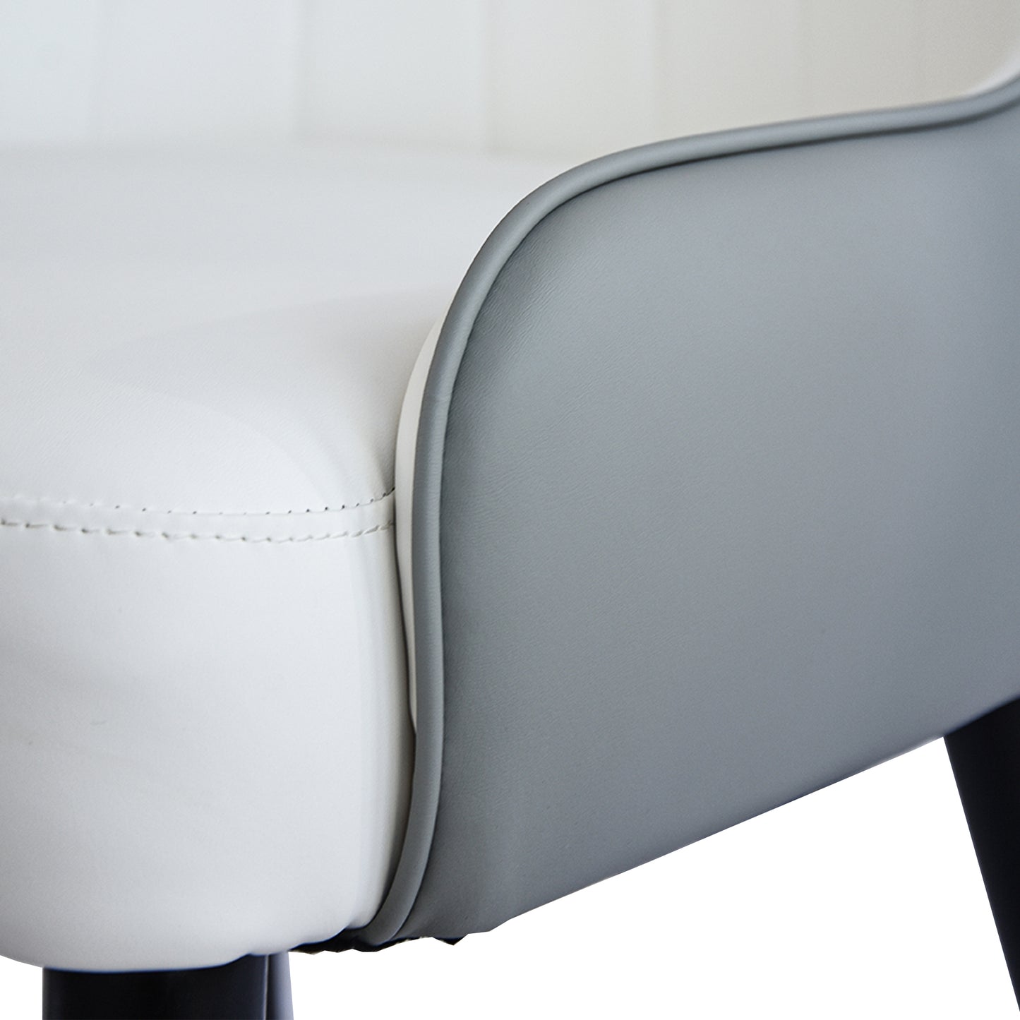 Closeup of a modern twotone faux leather chair in white and grey