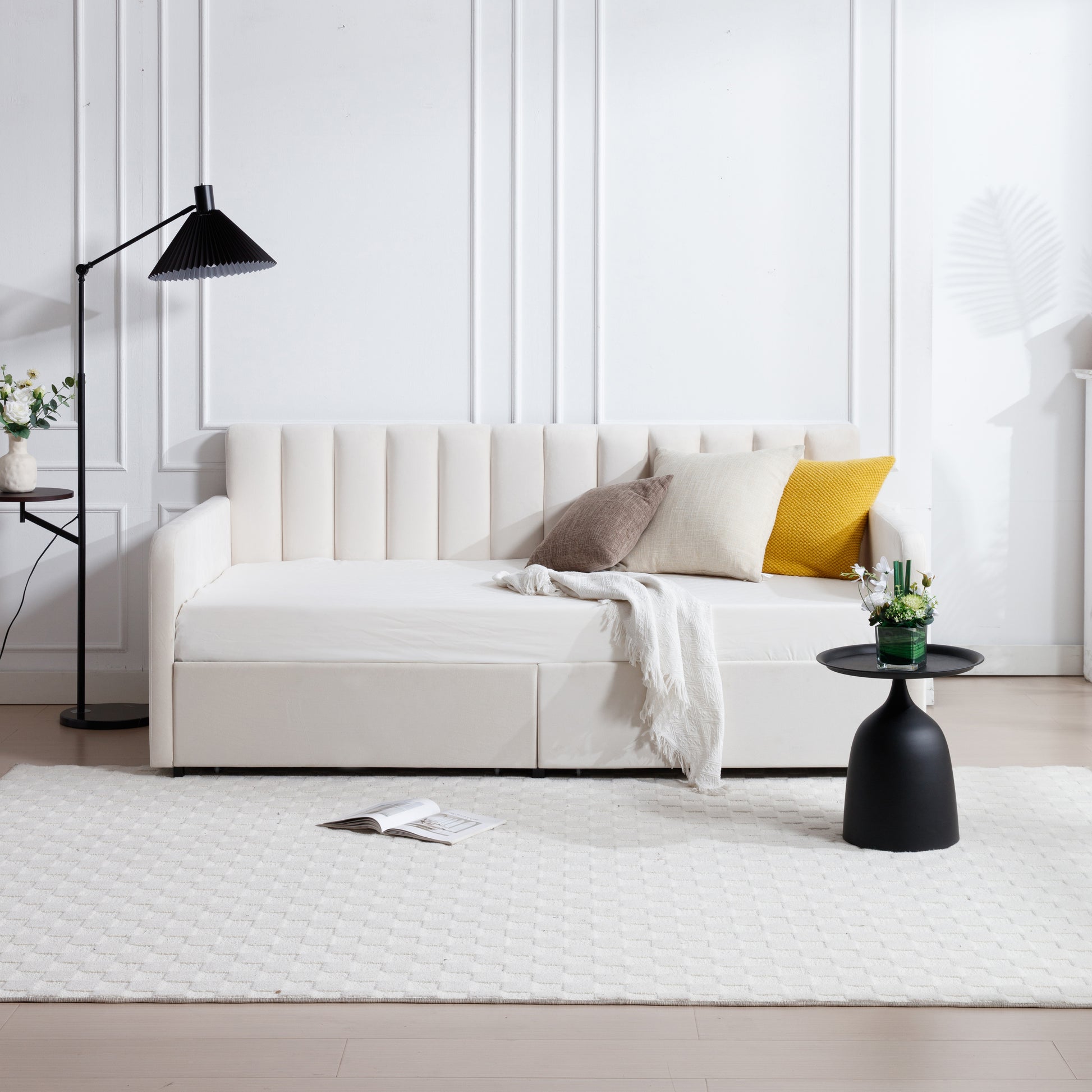 Cream velvet daybed with vertical channel tufting and integrated storage drawers