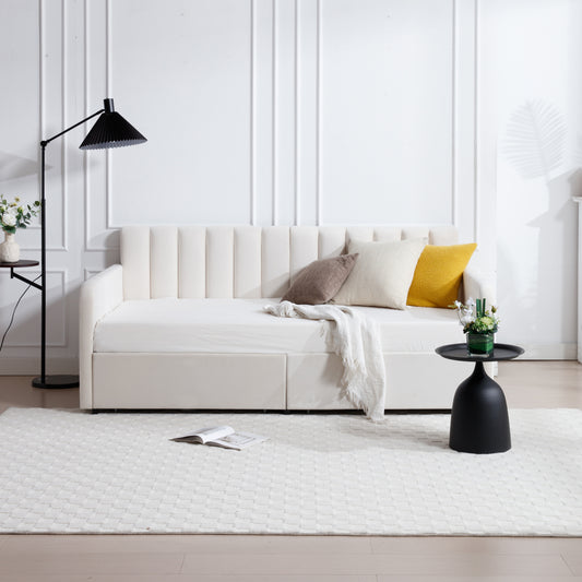 Cream velvet daybed with vertical channel tufting and integrated storage drawers