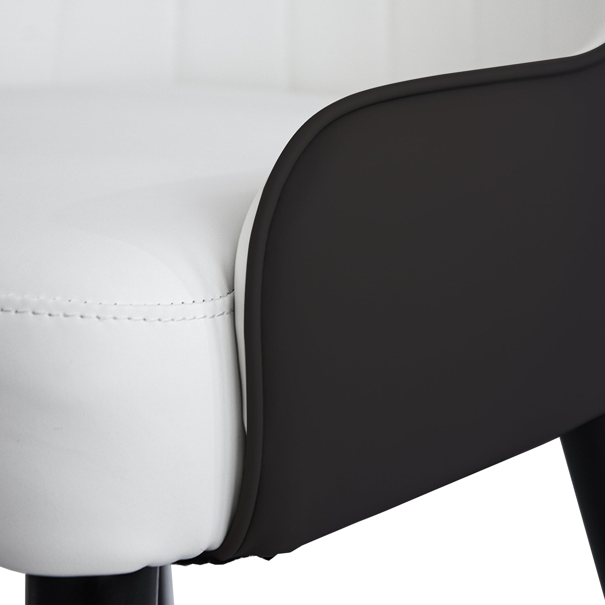Closeup of a white faux leather bar stool seat with black accents and stitching
