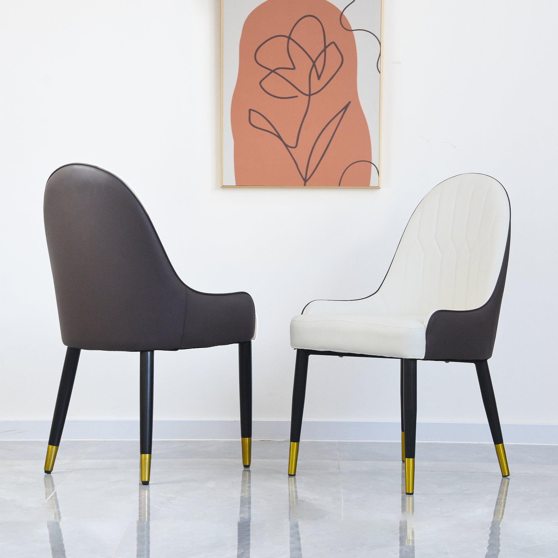 Modern dining chair with dark gray upholstery and goldtipped black legs