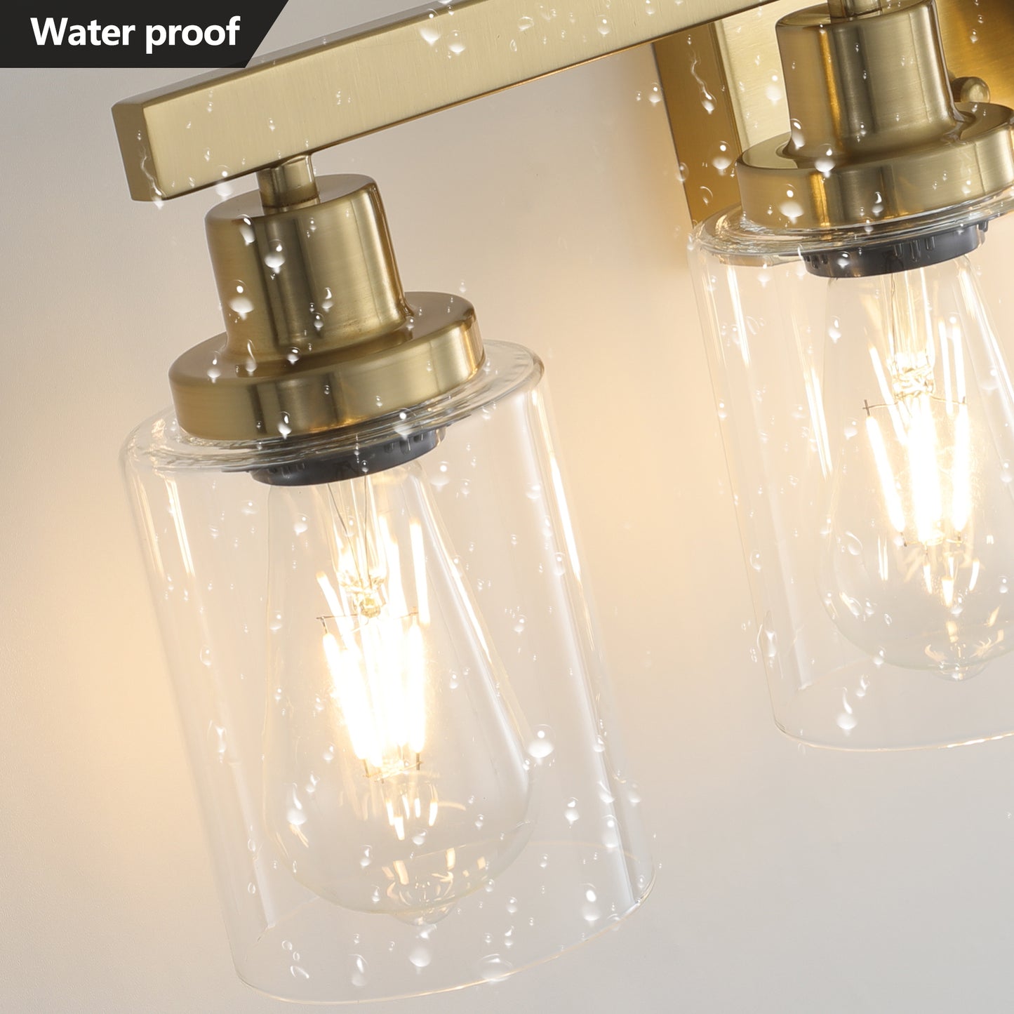 Brushed brass sconce with clear glass shade suitable for bathroom lighting