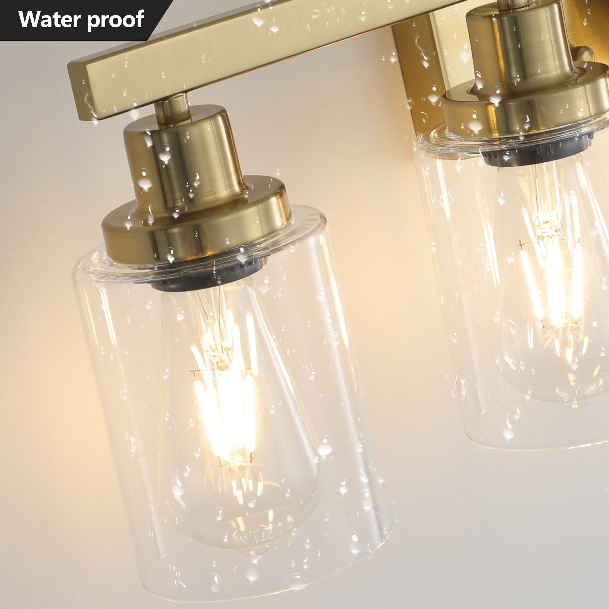 Brushed brass sconce with clear glass shade suitable for bathroom lighting