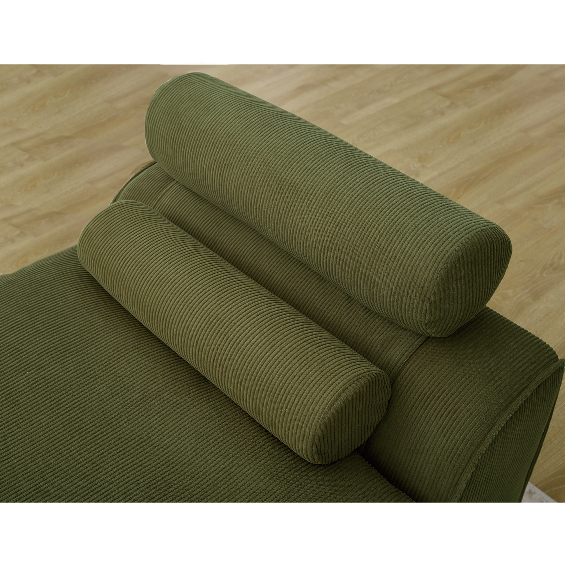 Closeup of plush olive green corduroy sofa with cylindrical bolster pillows